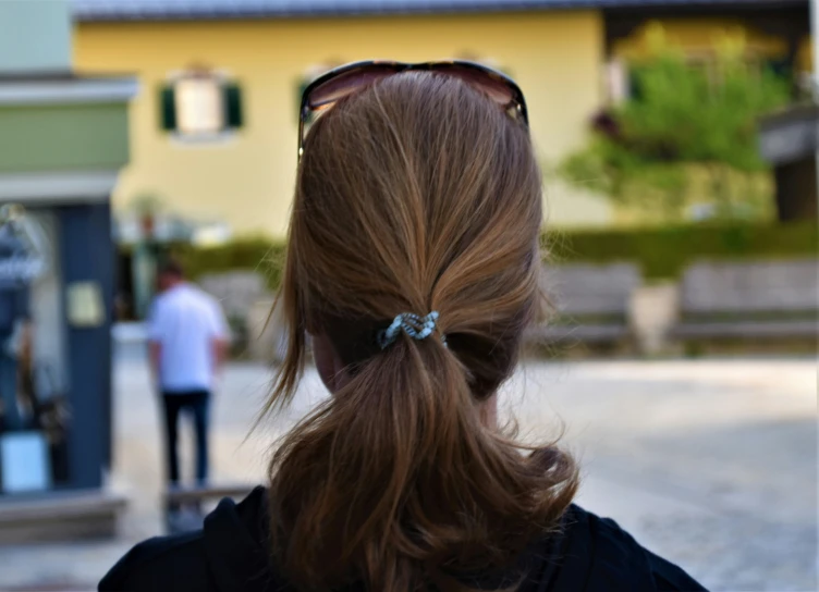 a lady with some hair in a pony tail