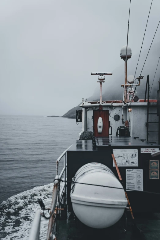 a small boat on the water with its buoy pulled up