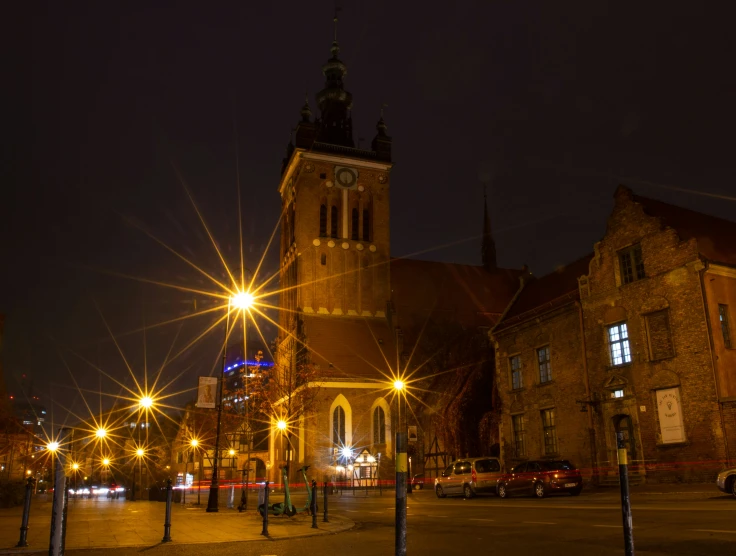 a clock tower at night on a city street