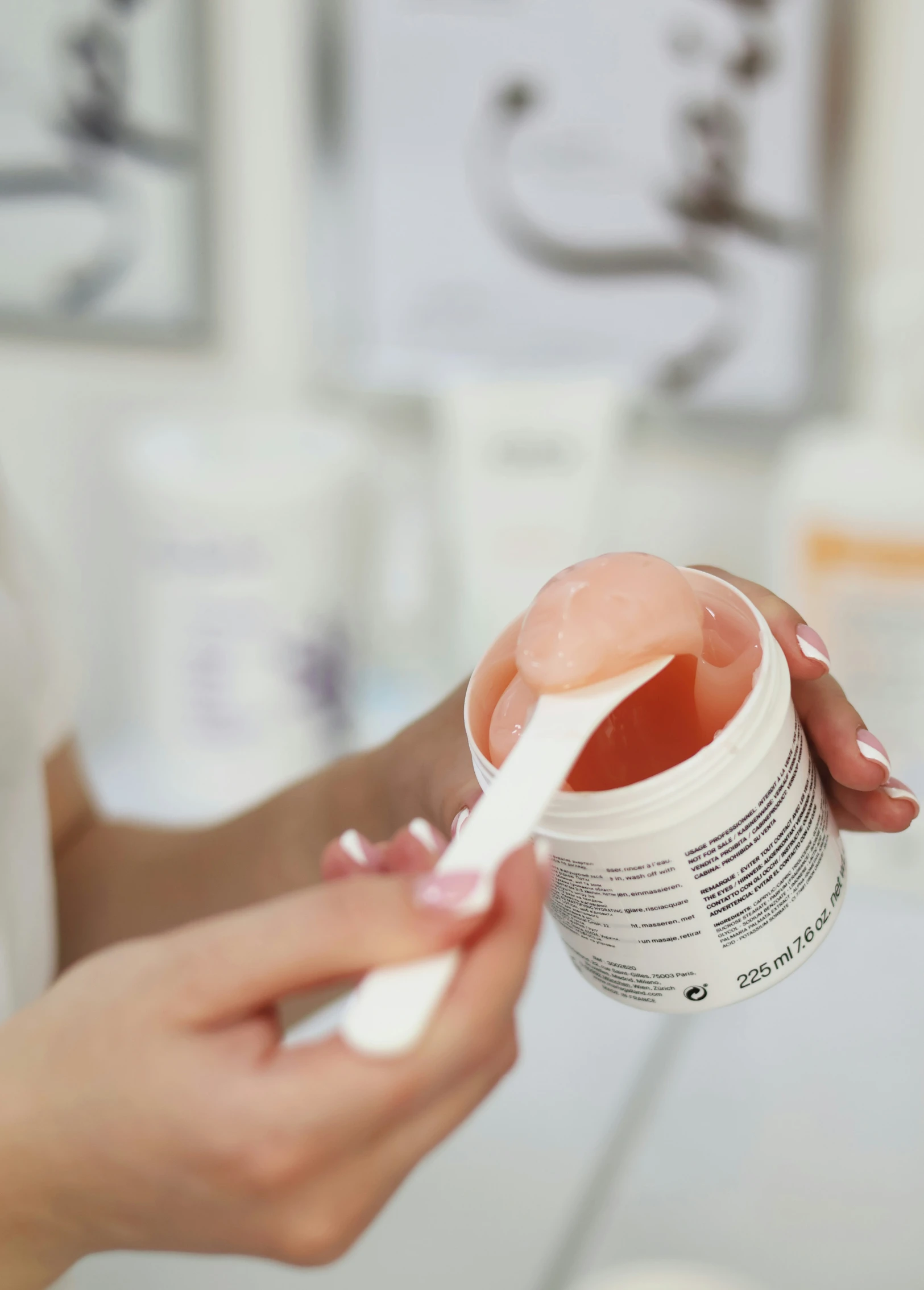 a person holding a jar of sunscreen in front of the camera