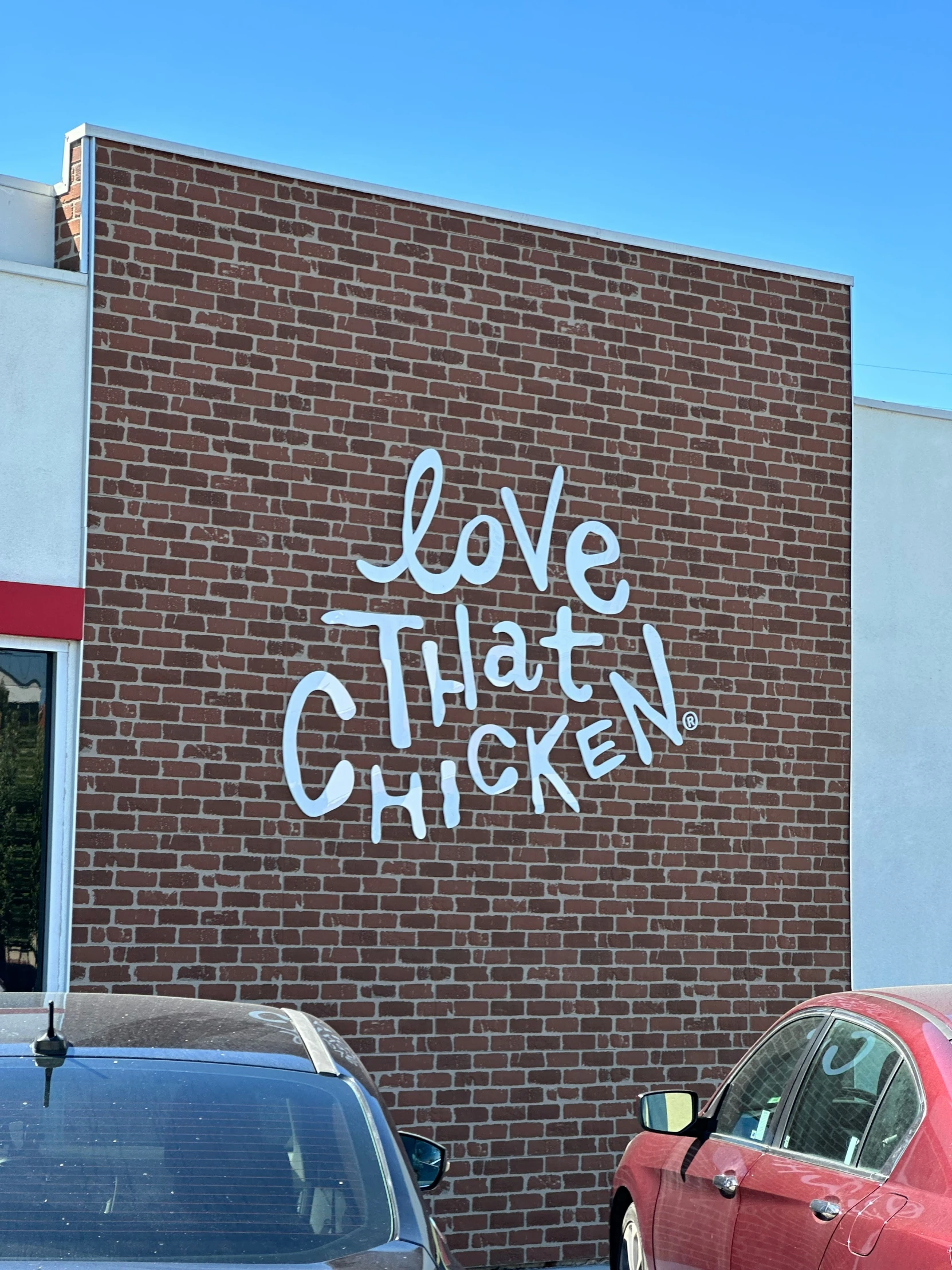 a mural on a building reads love that chicken