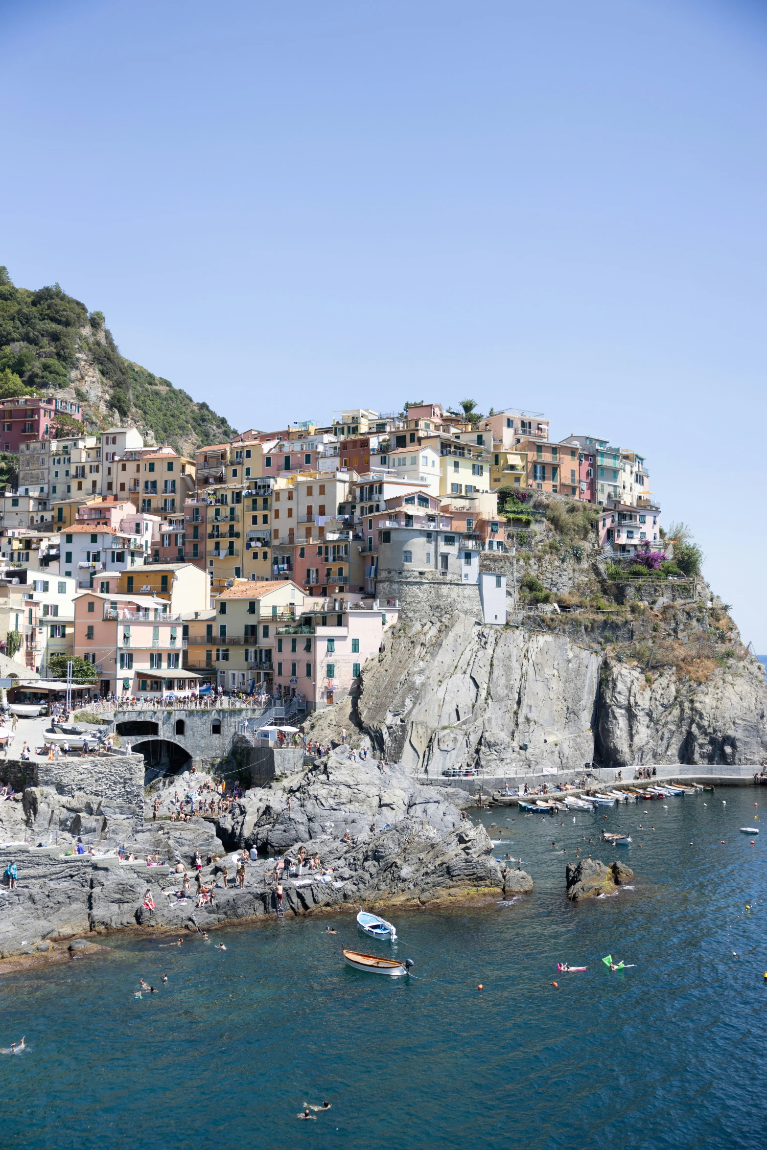 a city perched over the water on top of a hill