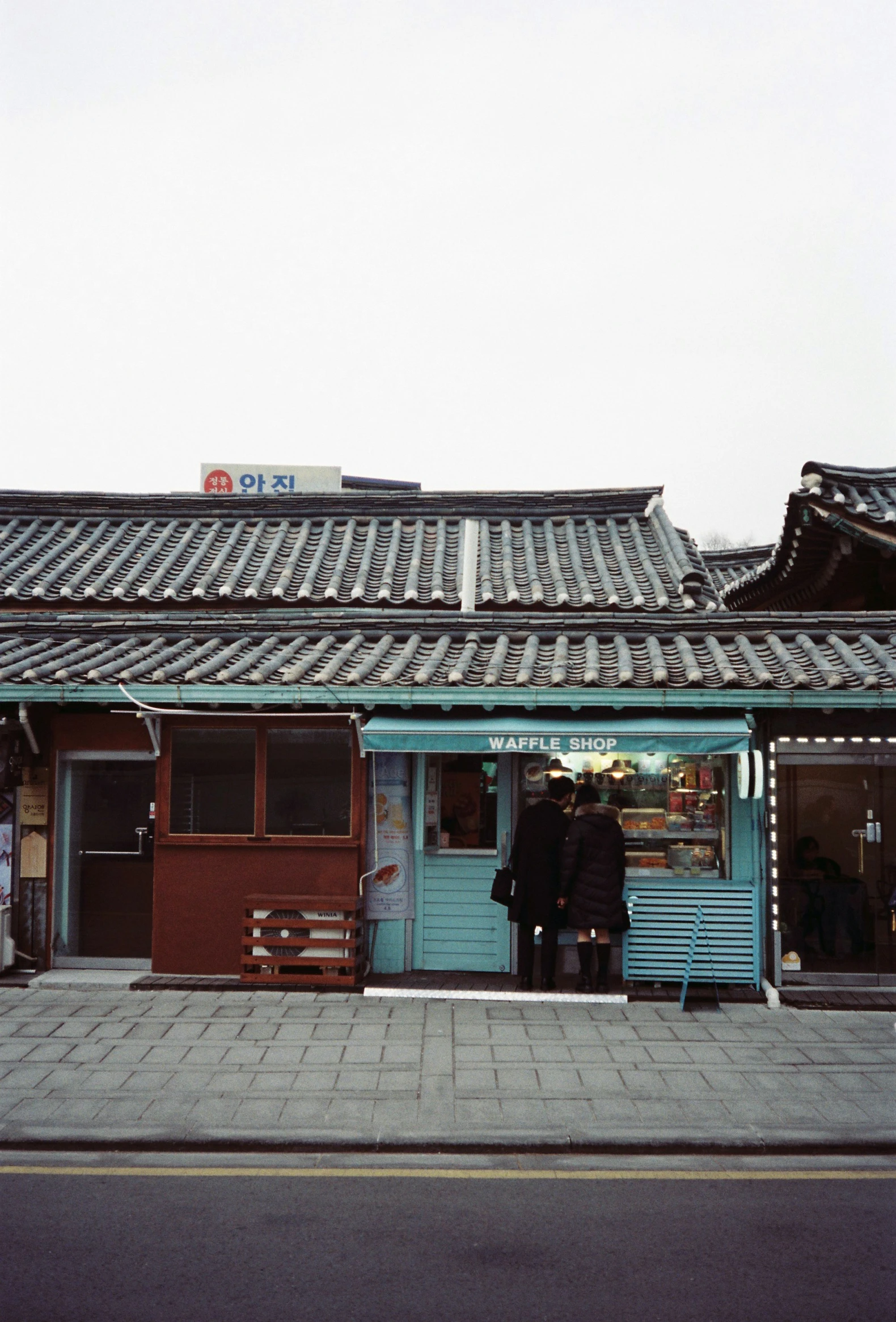 two people at the front door of a building