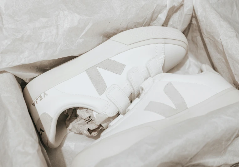 a pair of white sneakers in a bed sheet