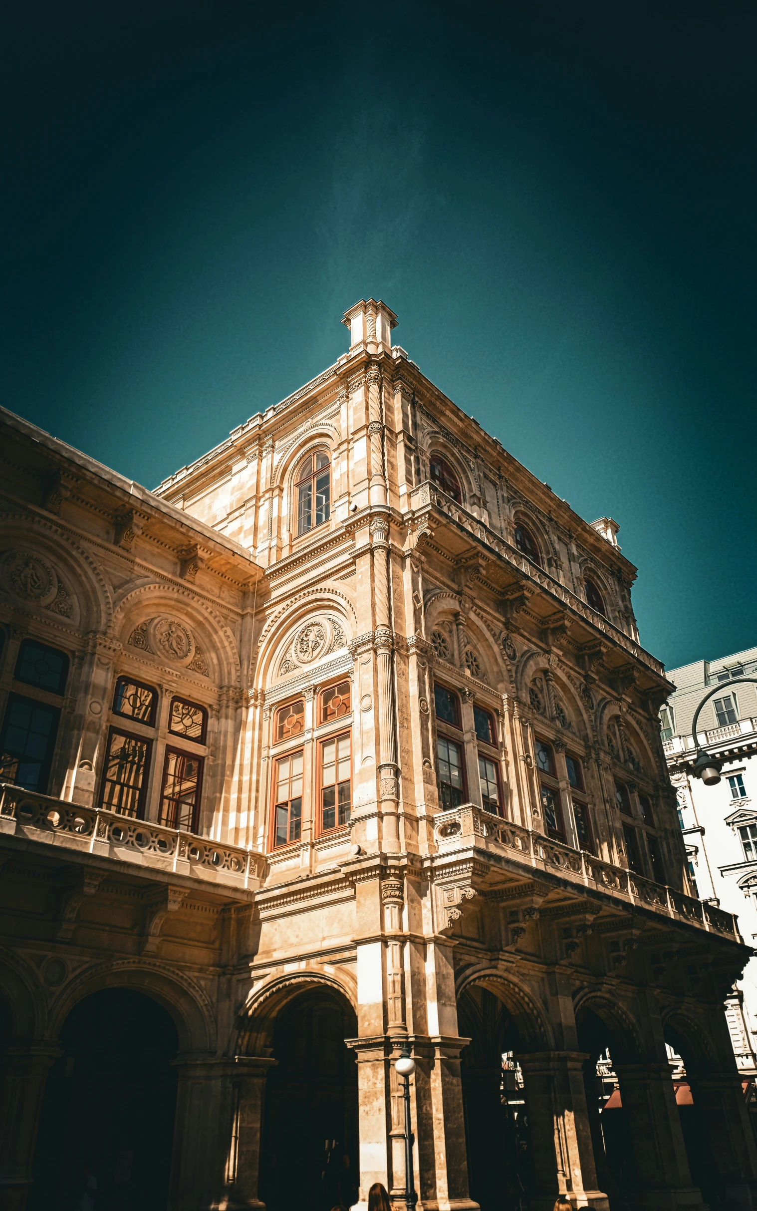 some people and a building in the middle of a square