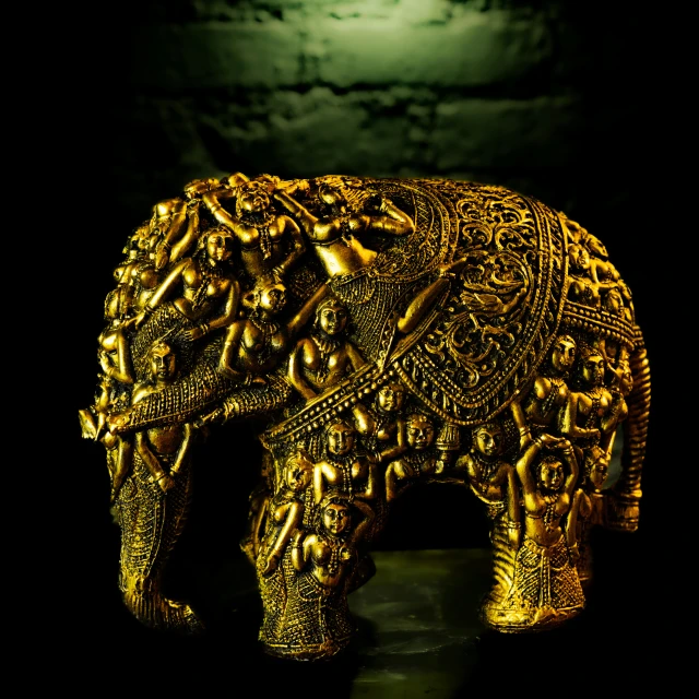 an elephant statue with an moon lit background