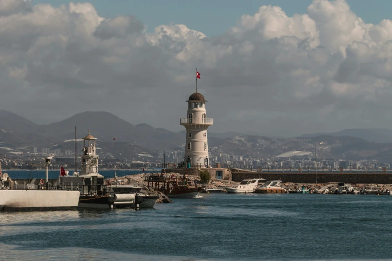 a large boat in the water near a light tower