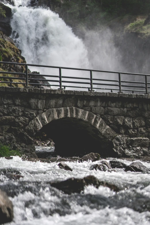 there is a person on the bridge that has water coming out of it