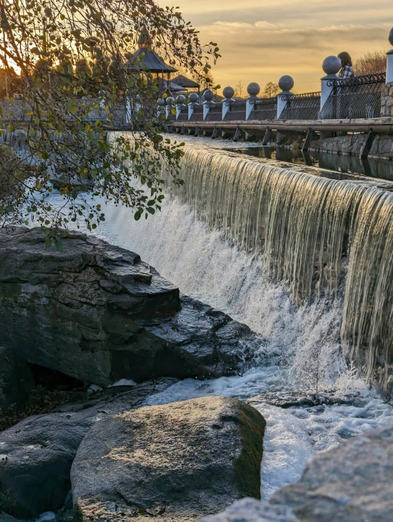waterfall at sunrise with people in  springs