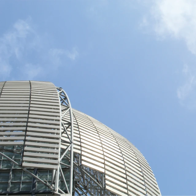 a close up of a white building with metal latticed on it