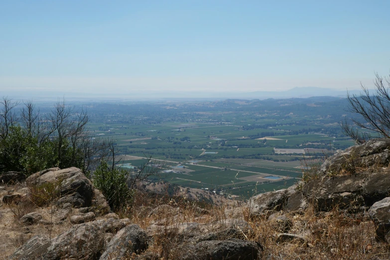 a mountain view with a lone bench near rocks