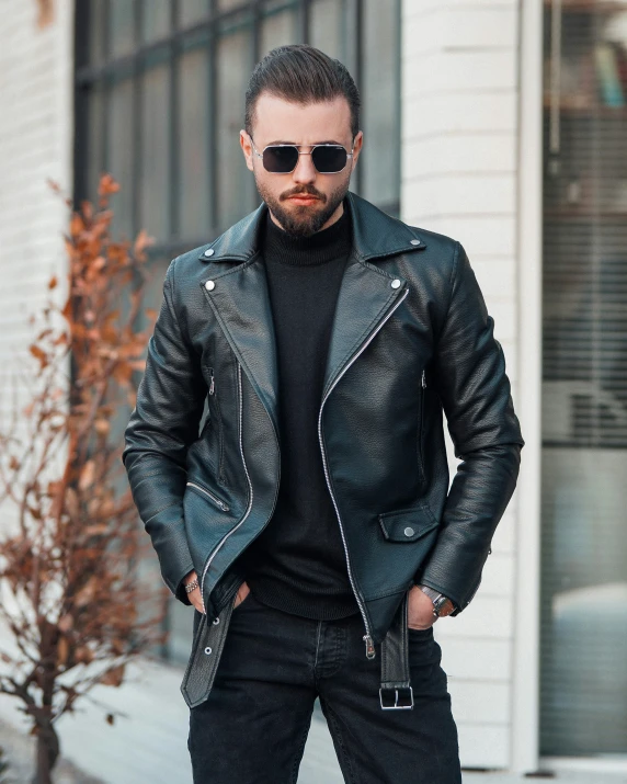 man standing outside in his black leather jacket and black sweater