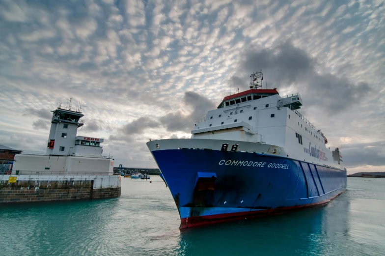 the large ship is leaving the dock at the seaside