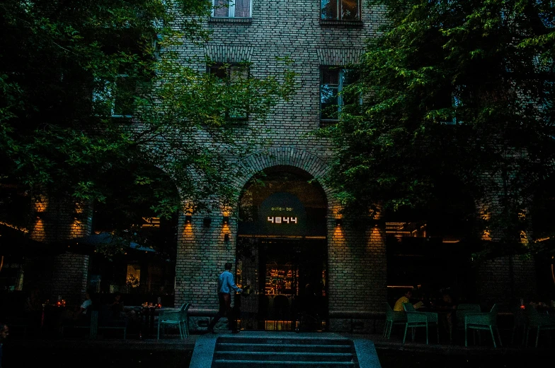 a very tall brick building with an entrance leading to the outside