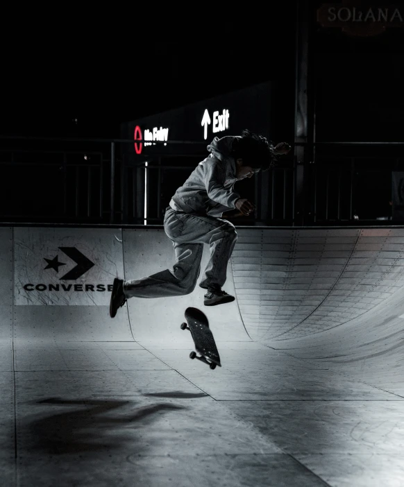 a man in a park with his skateboard up high