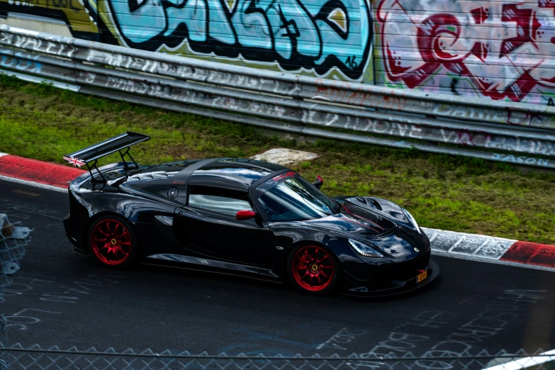 a black sports car with a top down on a track