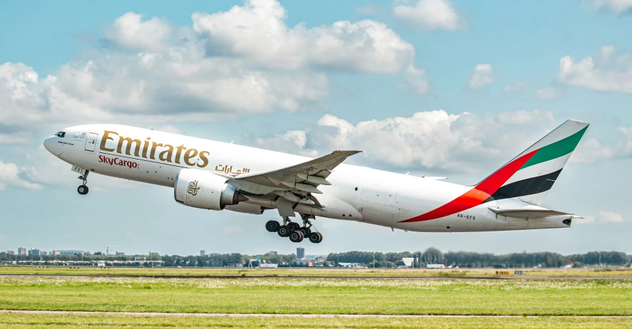 an emirates commercial airplane on the runway