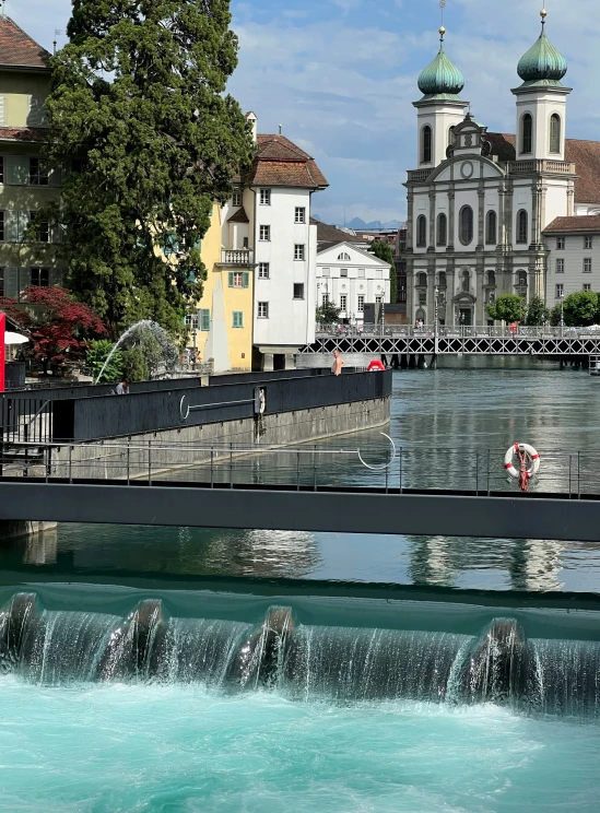 a clock tower is at the foot of the bridge