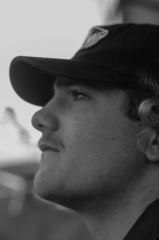 black and white pograph of man wearing cap