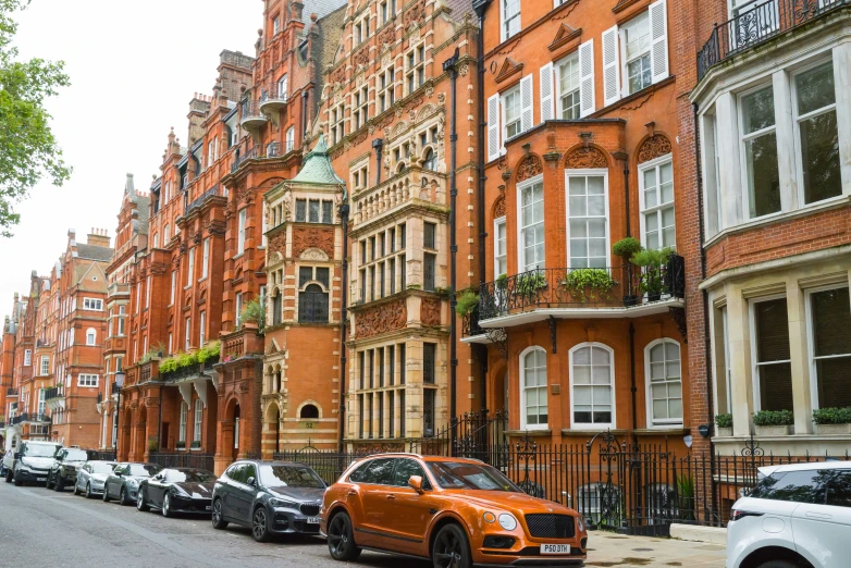 a bunch of buildings on the street with orange cars