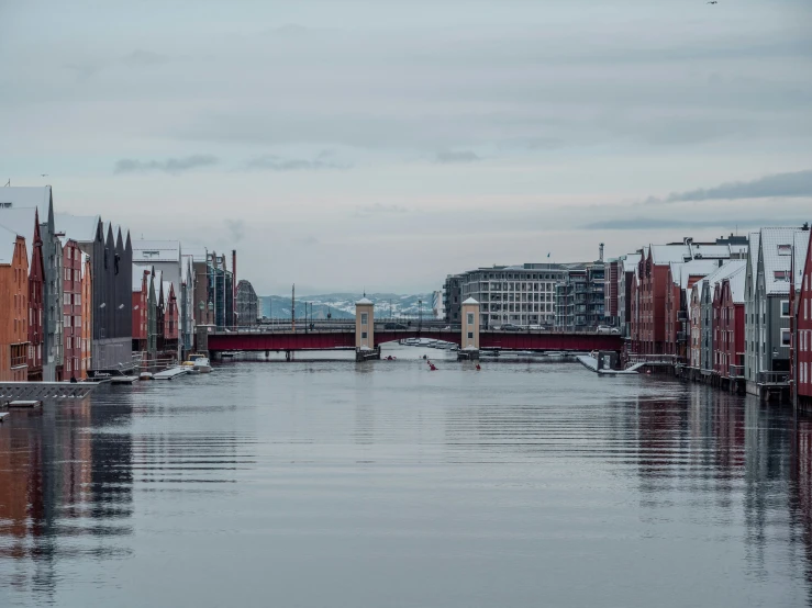 the sky and water are reflecting the buildings