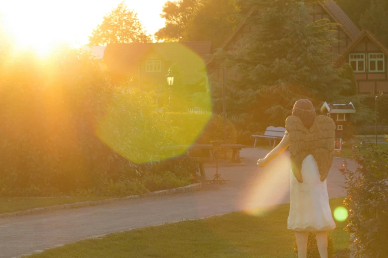 a girl is walking towards the sun