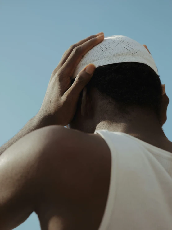 a man covering his head with a towel