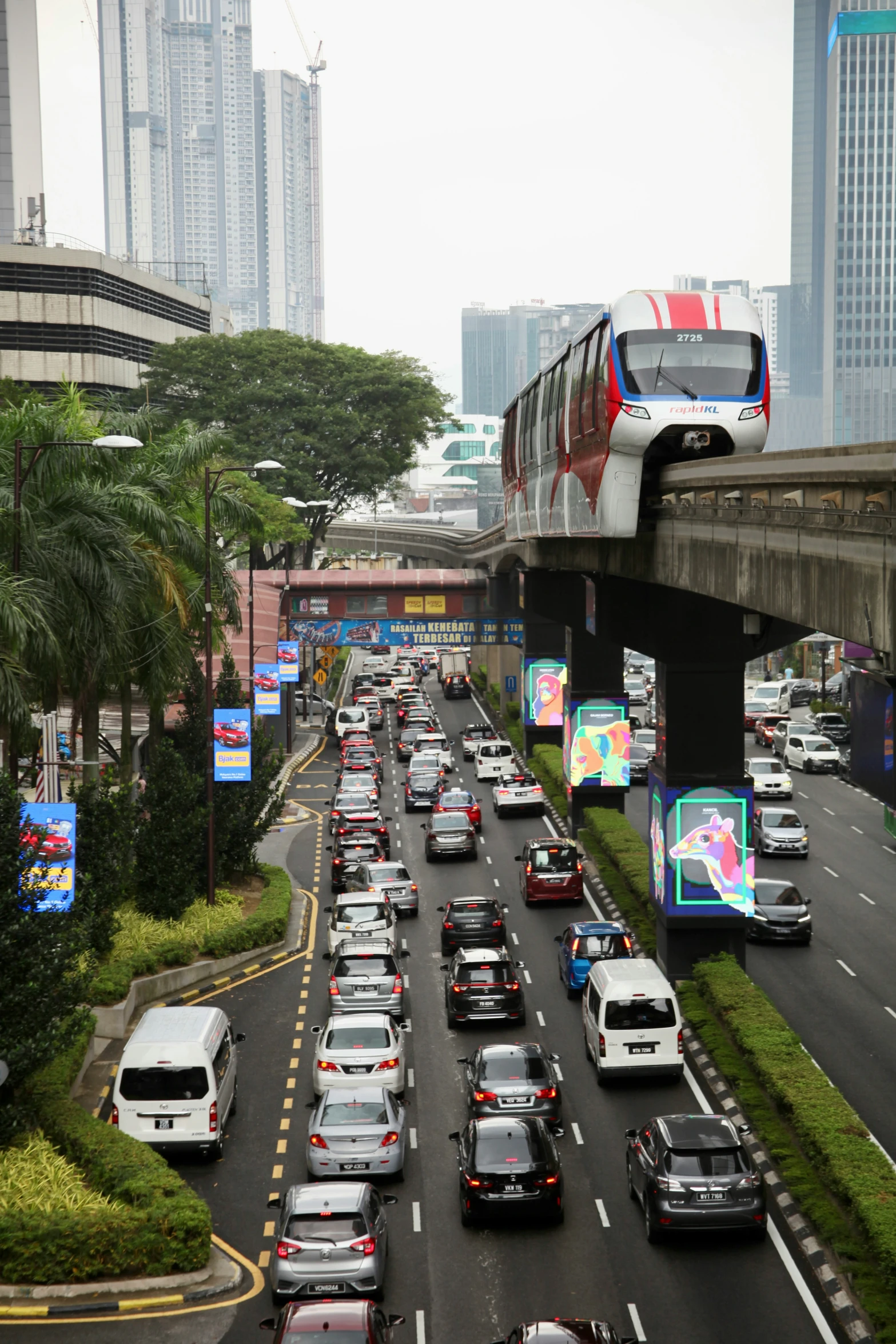 a busy freeway that is surrounded by high rise buildings