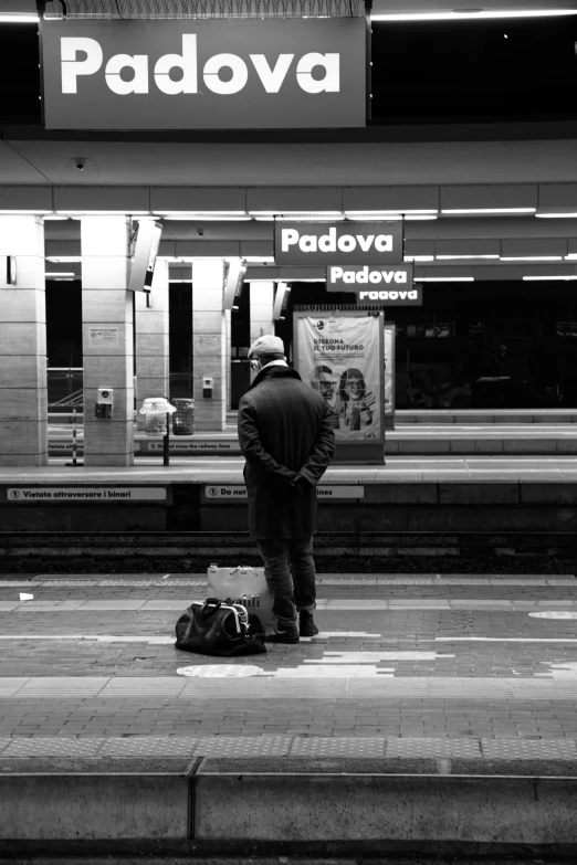 man waiting on the sidewalk waiting for the train