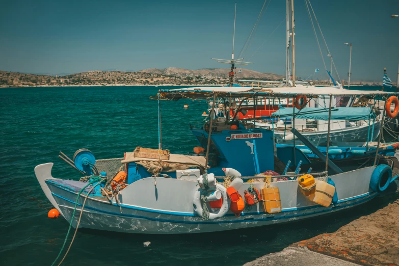 two boats tied to one another in the water