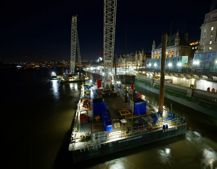 a barge is docked in the city by the river