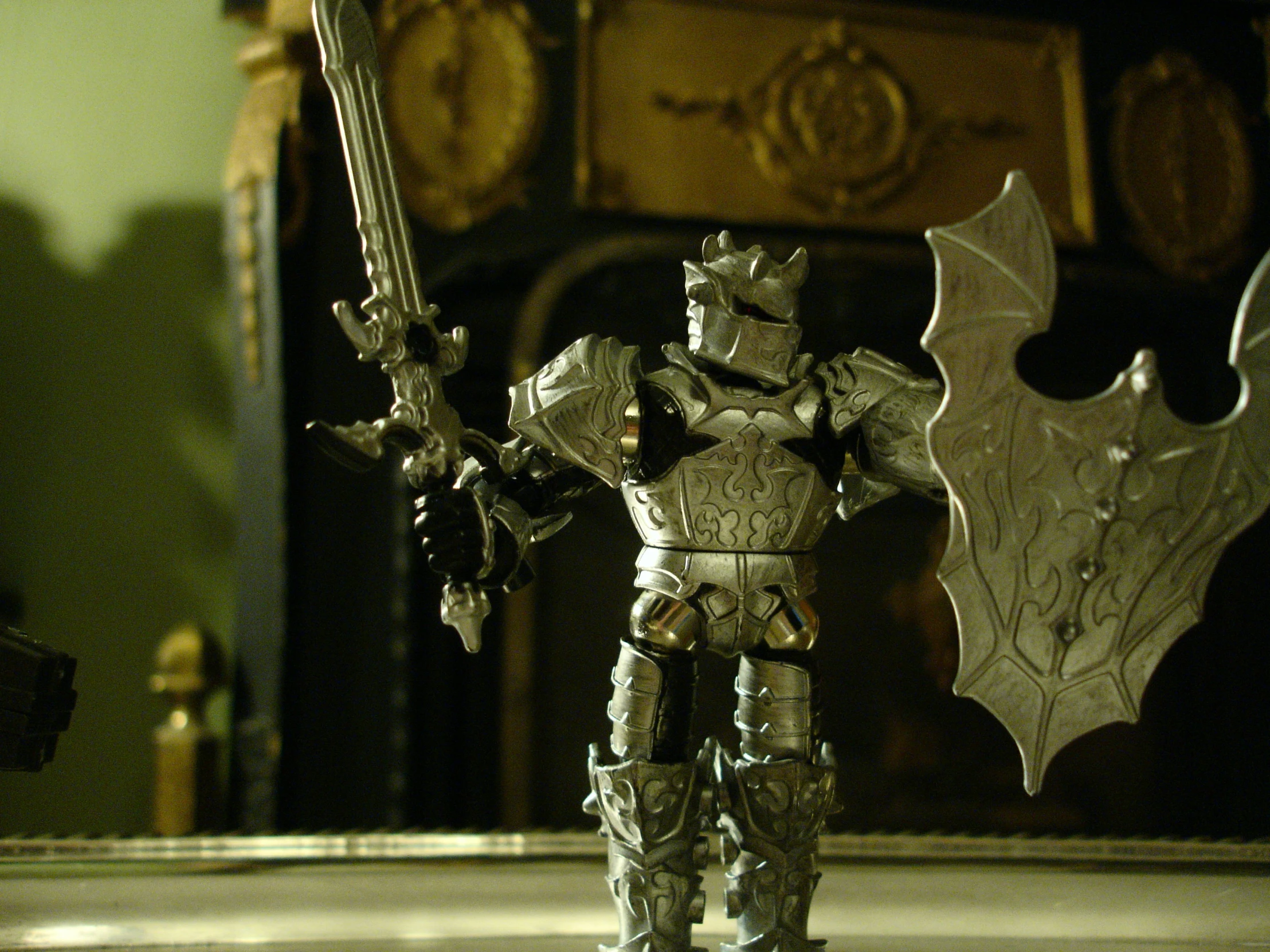 a toy figure with a bat like shadow on his hand