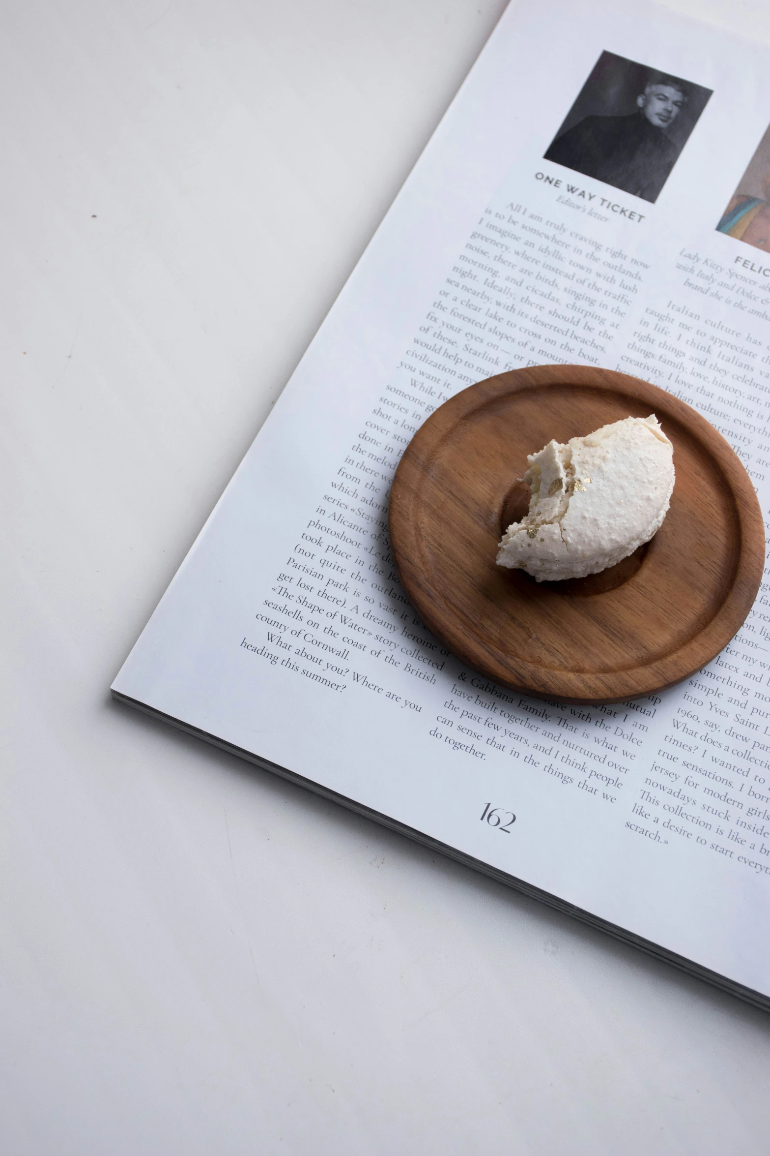 a piece of cream cheese sitting on top of a wooden plate