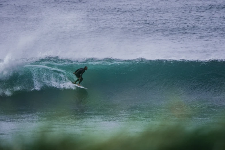 a surfer riding a big wave on his surfboard