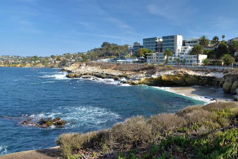 a city next to the ocean next to a beach