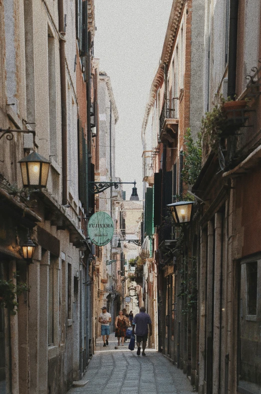 there are people walking down an alley way