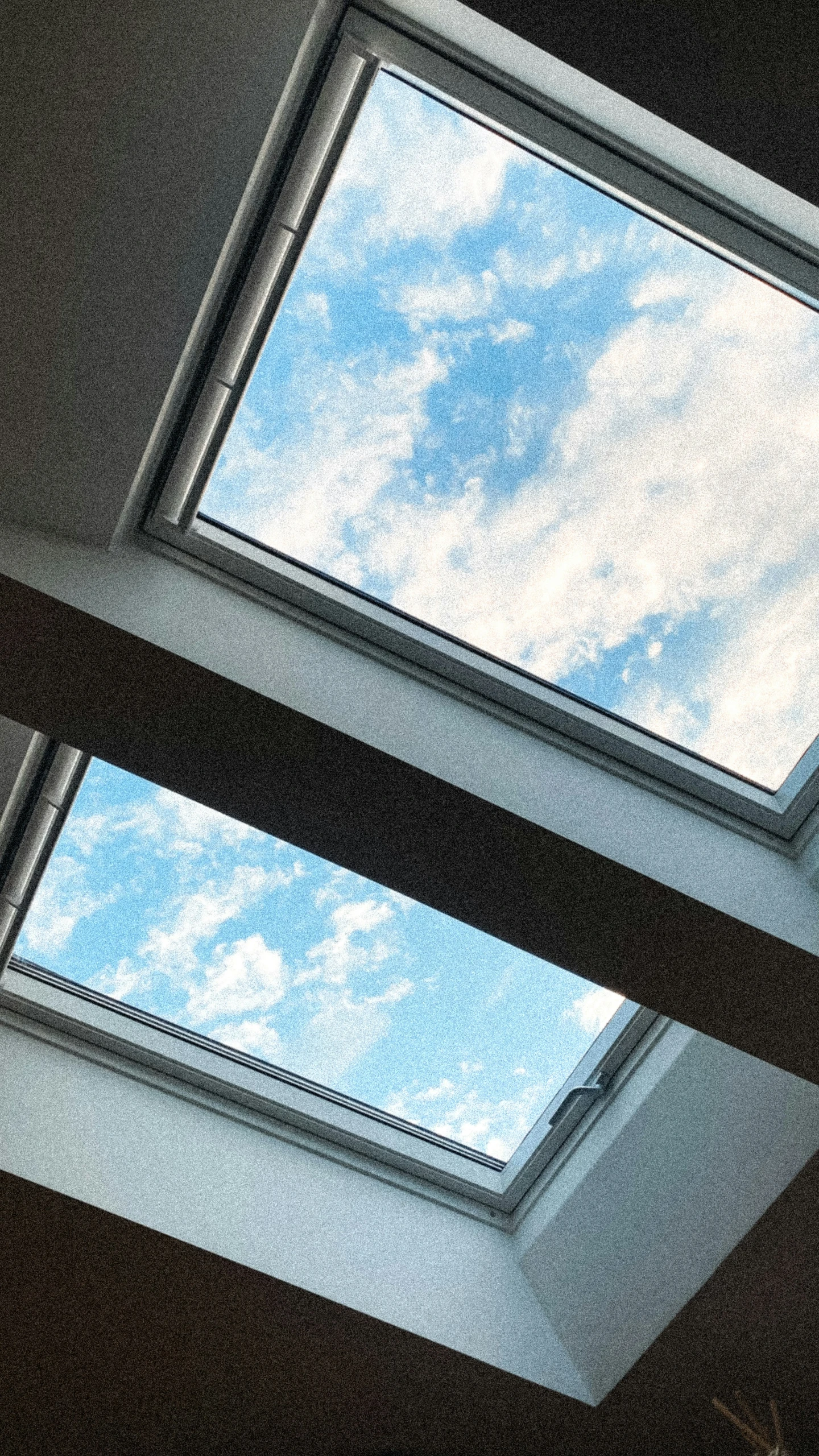 the sky through the open roof tiles in the room