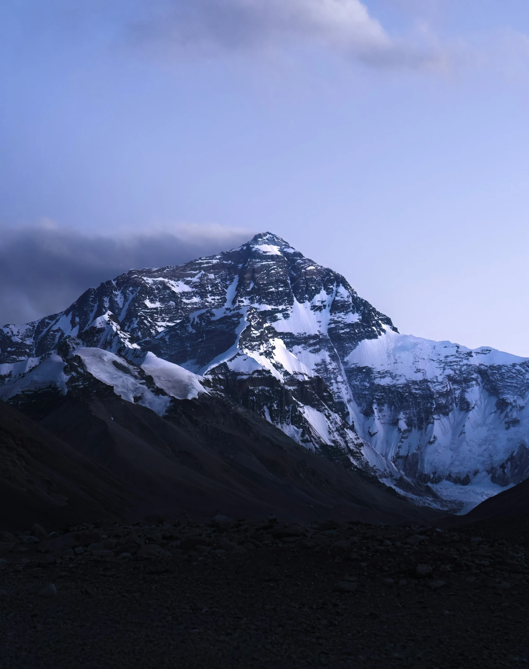 a large snow covered mountain range on the side of it