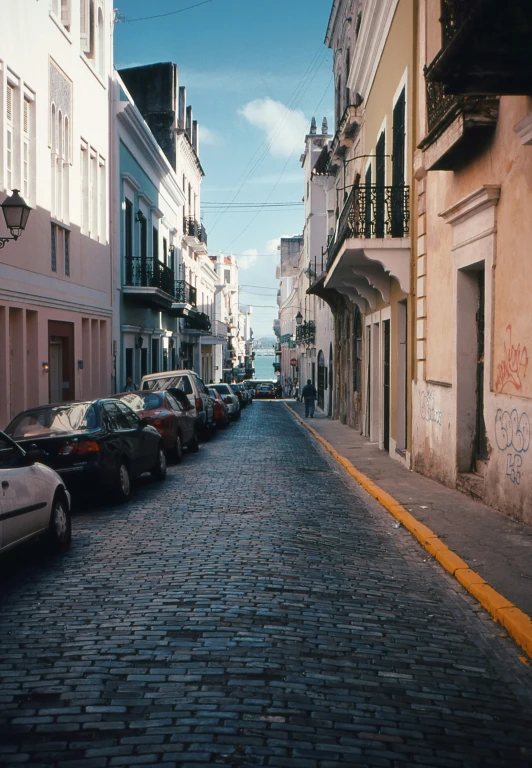 a street with cars parked along it and side walk