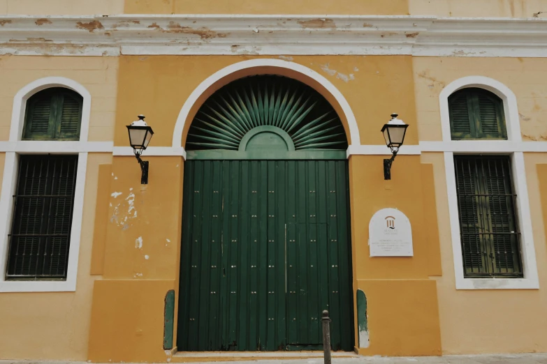 the front doors to a building are green