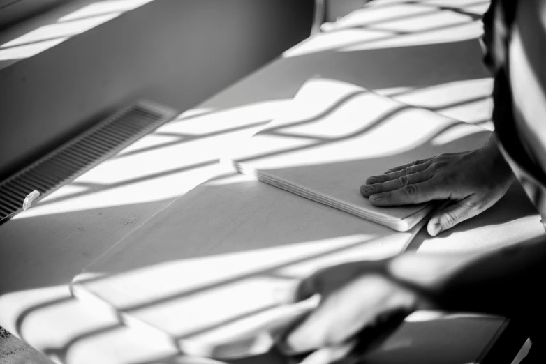 person reading a book while sitting on a bench