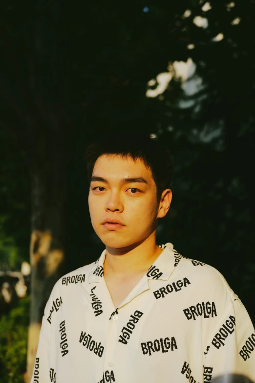 young man standing near a tree at night