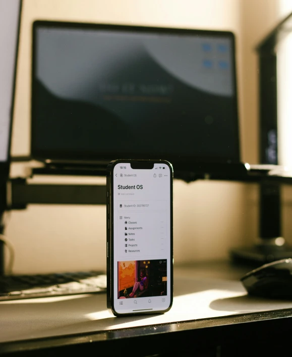 a cell phone and mouse on top of a desk