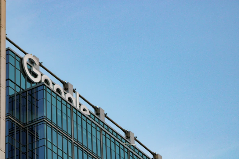 a logo on the front of a large glass building