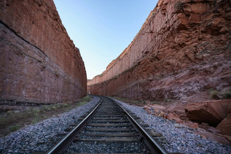 a railroad track in the middle of a canyon