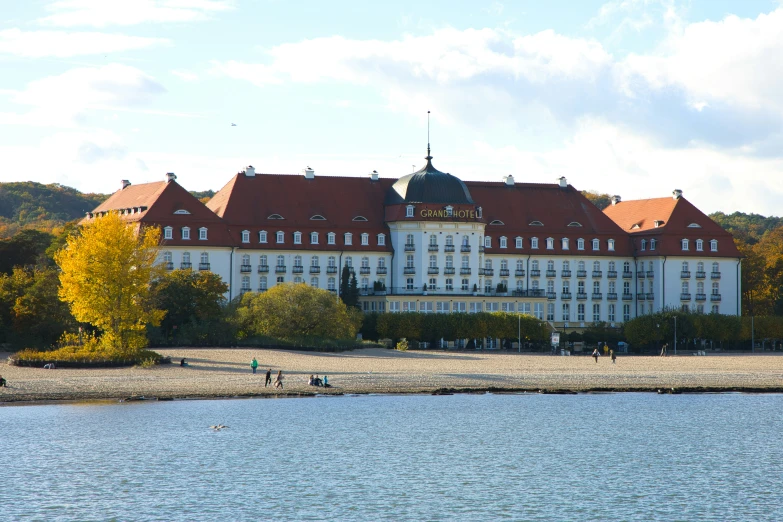 a palace next to water with clouds in the sky