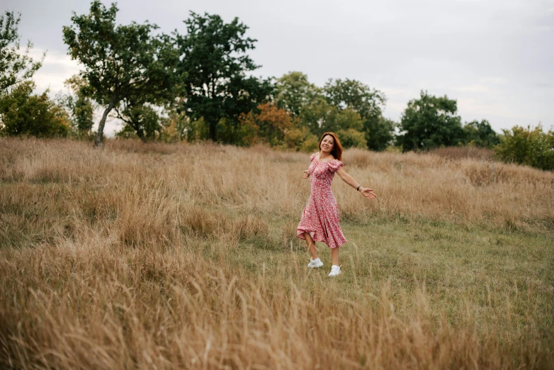 a person standing in a field with a frisbee