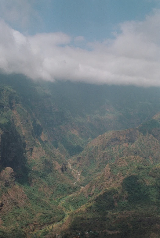 a view of some mountains with animals grazing on it