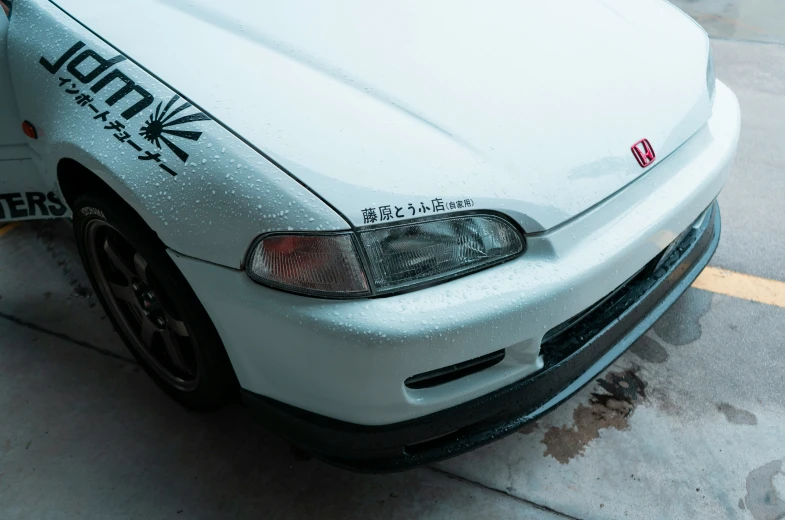 a white car has been decorated with japanese characters