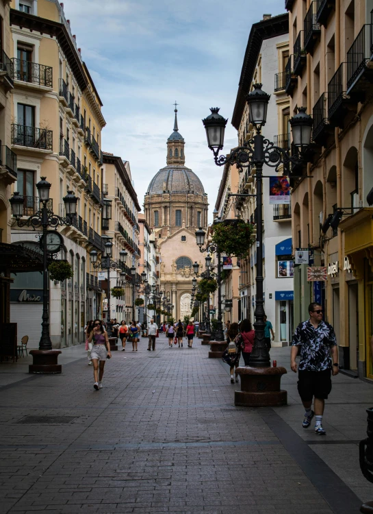 a couple of people walk down a very narrow street